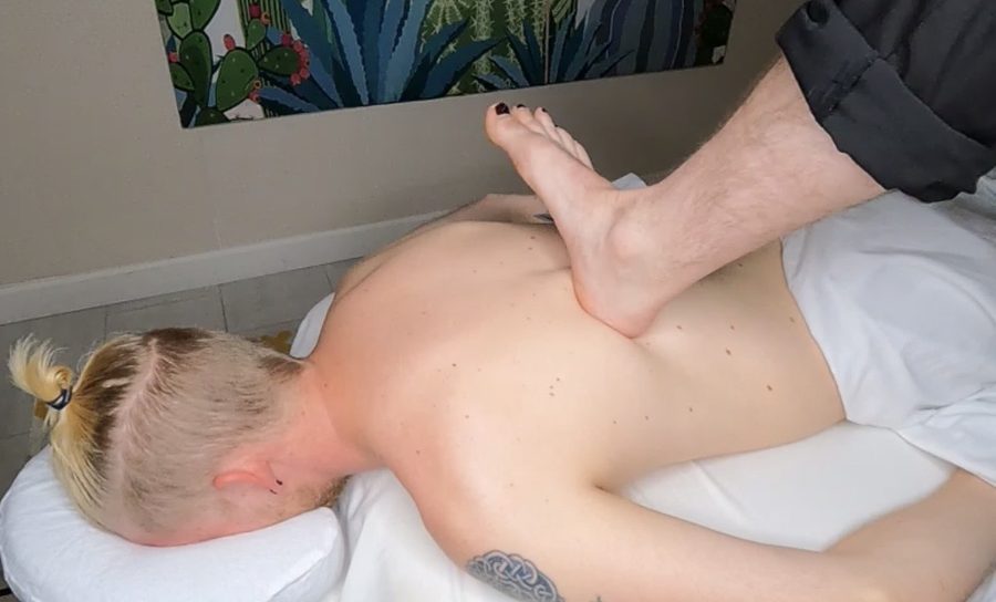 Sole Symphony Ashiatsu barefoot massage therapist applying foot pressure to client's back at Awaken Zen Spa in Mesa, AZ